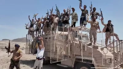 This image taken from undated video released by the Houthi-run Al-Masirah television channel on Saturday, Sept. 12, 2026, shows Houthi fighters chanting and raising rifles atop a military vehicle in Dhubab district, Taiz province, Yemen, according to the channel. (Al-Masirah TV via AP)