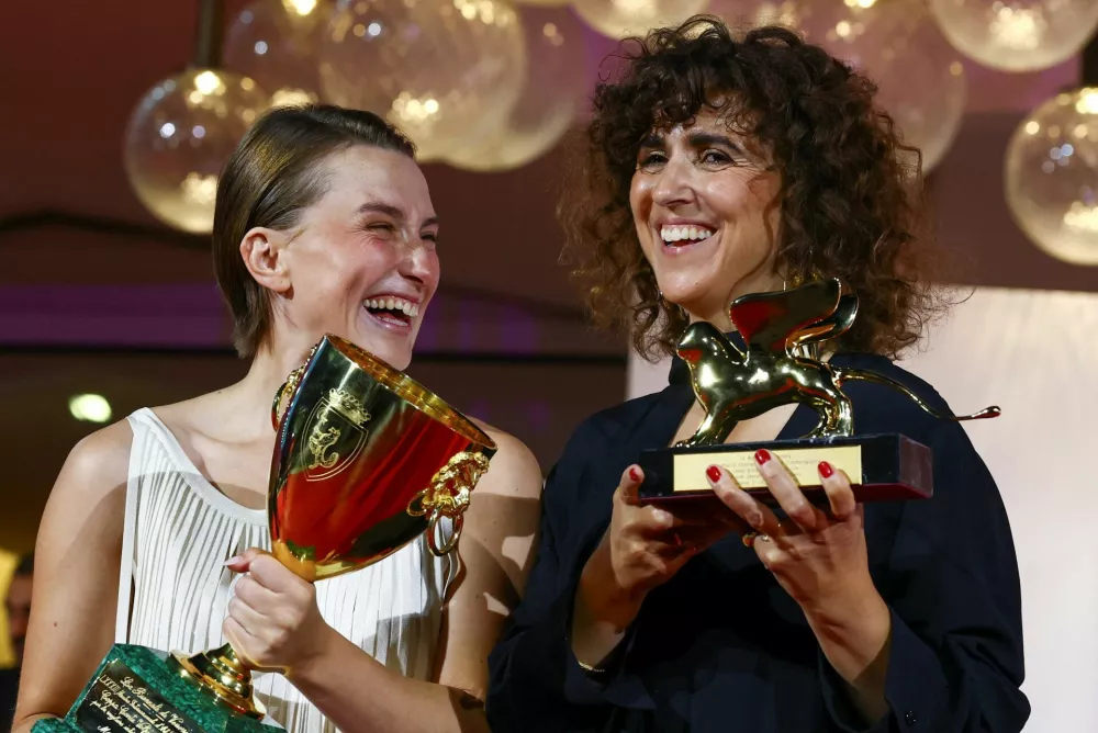 Mathilde Arcel poses with the Coppa Volpi Award for Best Actress, accompanied by May el-Toukhy, winner of the Golden Lion Award for Best Film for the movie "Woman Unknown", during the closing ceremony of the 83rd Venice International Film Festival, Italy, September 12, 2026. REUTERS/Yves Herman