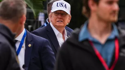 U.S. President Donald Trump, center, attends the Irish Open golf tournament at Trump International Golf Links in Doonbeg, Ireland, Sunday, Sept. 13, 2026. (AP Photo/Julia Demaree Nikhinson)