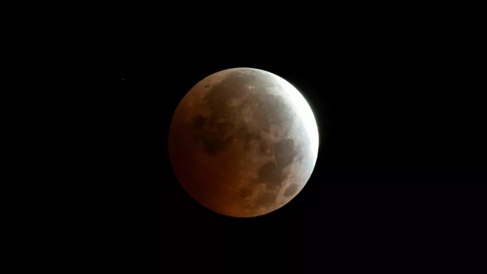 The moon appears in the sky during a partial lunar eclipse over Madrid, Spain, August 28, 2026. REUTERS/Thomas Peter
