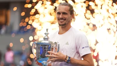 Alexander Zverev, of Germany, holds his trophy after winning the men's singles final of the U.S. Open tennis championships against Ben Shelton, of the United States, Sunday, Sept. 13, 2026, in New York. (AP Photo/Frank Franklin II)