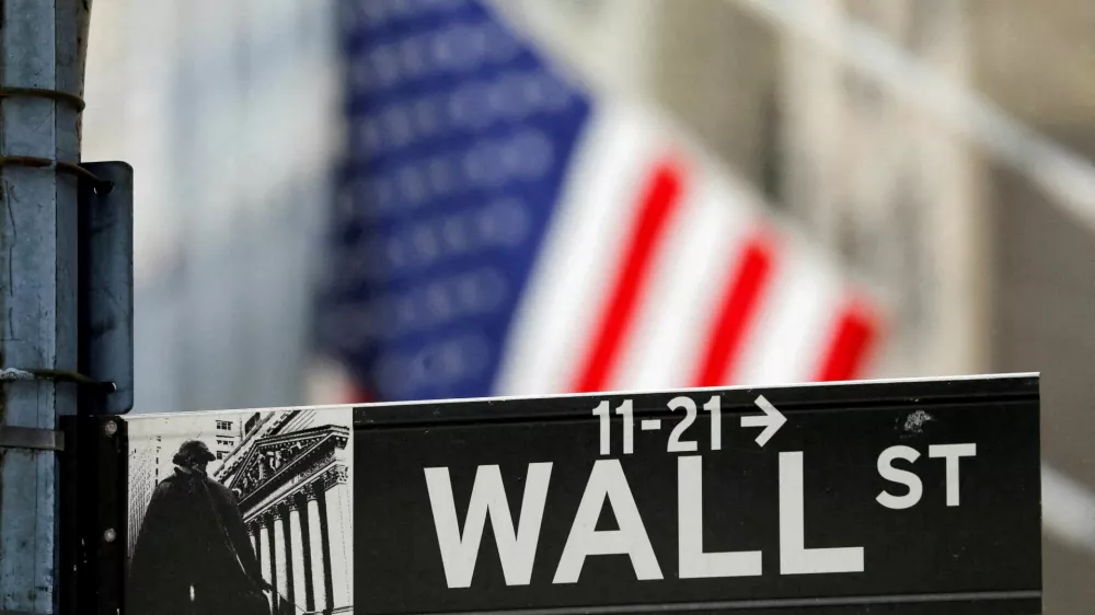 FILE PHOTO: A street sign for Wall Street is seen outside the New York Stock Exchange (NYSE) in New York City, New York, U.S., July 19, 2021. REUTERS/Andrew Kelly/File Photo