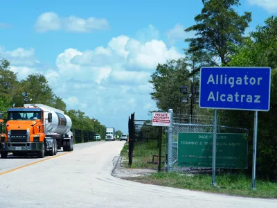 FILE - Trucks come and go from the "Alligator Alcatraz" immigration detention center in the Florida Everglades, Aug. 28, 2025, in Collier County, Fla. (AP Photo/Rebecca Blackwell, File)