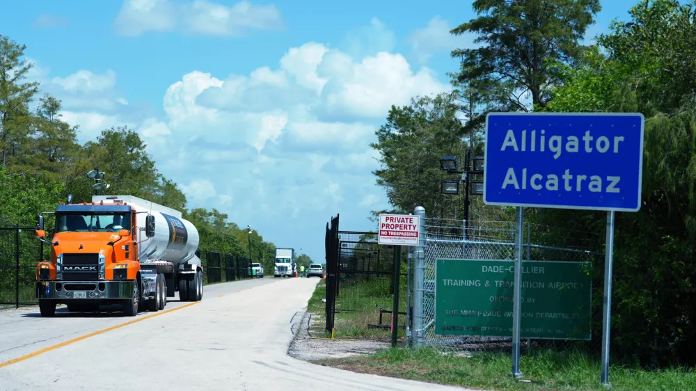 FILE - Trucks come and go from the "Alligator Alcatraz" immigration detention center in the Florida Everglades, Aug. 28, 2025, in Collier County, Fla. (AP Photo/Rebecca Blackwell, File)