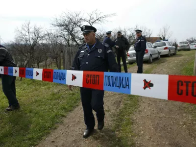 A policeman stands guard in the village of Velika Ivanca, about 40 km (25 miles) southwest of Belgrade April 9, 2013. A gunman shot dead 13 people, including his mother and son, in an early-morning rampage through a small Serbian village southwest of the capital Belgrade on Tuesday, authorities said. Those killed included a two-year-old child. The gunman, identified by police as Ljubisa Bogdanovic - a war veteran born in 1953 - also shot his wife before turning the gun on himself. Both were in critical condition in hospital, police said.  REUTERS/Marko Djurica (SERBIA - Tags: CRIME LAW)