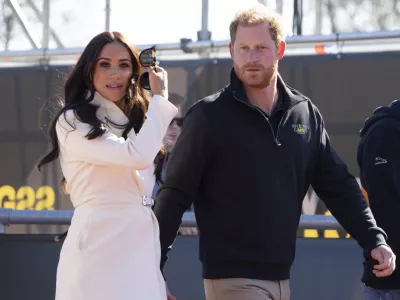 Prince Harry and Meghan Markle, Duke and Duchess of Sussex visit the track and field event at the Invictus Games in The Hague, Netherlands, Sunday, April 17, 2022. The week-long games for active servicemen and veterans who are ill, injured or wounded opened Saturday in this Dutch city that calls itself the global center of peace and justice. (AP Photo/Peter Dejong)