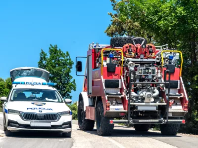 Labin,Croatia, 2023: Police car (Policija) and fire truck (vatrogasci) on a country road near Labin