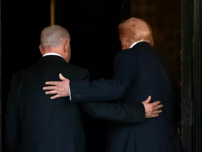 FILE PHOTO: U.S. President Donald Trump and Israeli Prime Minister Benjamin Netanyahu embrace as they walk into Trump's Mar-a-Lago club in Palm Beach, Florida, U.S., December 29, 2025. REUTERS/Jonathan Ernst/File Photo