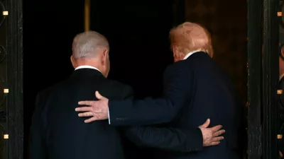 FILE PHOTO: U.S. President Donald Trump and Israeli Prime Minister Benjamin Netanyahu embrace as they walk into Trump's Mar-a-Lago club in Palm Beach, Florida, U.S., December 29, 2025. REUTERS/Jonathan Ernst/File Photo