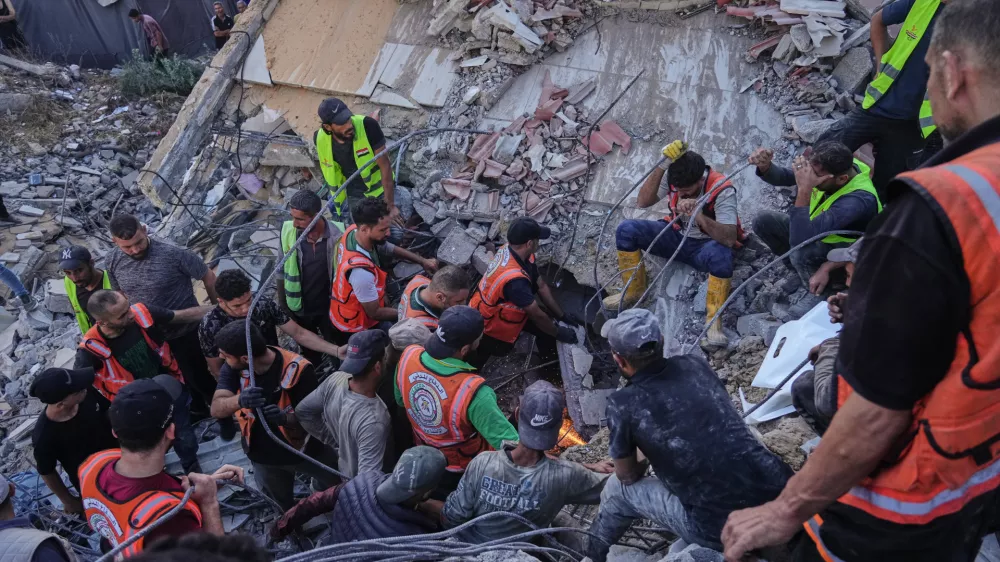Palestinian civil defense crews search for bodies and survivors in the rubble of a collapsed building that housed displaced Palestinians and was heavily damaged during the Israel-Hamas war, in Gaza City, Wednesday, Sept. 16, 2026. (AP Photo/Jehad Alshrafi)