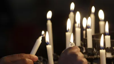 People light candles in the Oslo Cathedral in memory of the victims of Friday's bomb and shooting massacre in Oslo, Norway, Monday, July 25, 2011. The man who has confessed to carrying out a bombing and shooting spree that left 93 people dead in Norway will be held for at least eight weeks, half of that in complete isolation, after a closed hearing in which he said his terror network had two other cells. (AP Photo/Frank Augstein)