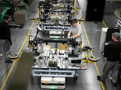 FILE PHOTO: Workers assemble components on the production line for the Qashqai model car at the Nissan car factory in Sunderland, Britain, December 16, 2025. REUTERS/Phil Noble/File Photo