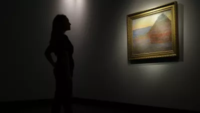 A member of staff poses for the media next to a work of art by Claud Mont entitled ' Merle' (Granistack), 1891, at Christie's auction house in London, Monday, Oct. 24, 2016. The painting is to be sold in New York on Nov. 16, with an estimated value of 45 million pounds (55 million US$). (AP Photo/Alastair Grant)