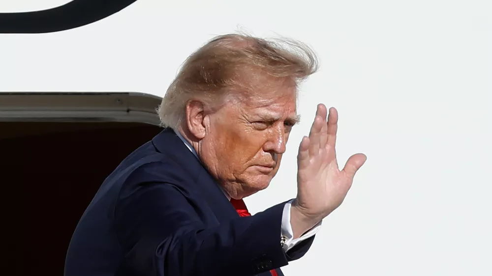 President Donald Trump waves as he boards Air Force One upon his departure at Joint Base Andrews, Md., Wednesday, Sept. 16, 2026. (AP Photo/Luis M. Alvarez)