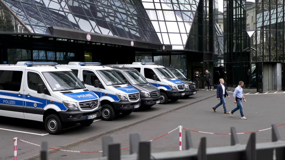 Police officers walk in the backyard of Deutsche Bank headquarters during a raid in Frankfurt, Germany, Thursday, Nov. 29, 2018. (AP Photo/Michael Probst)