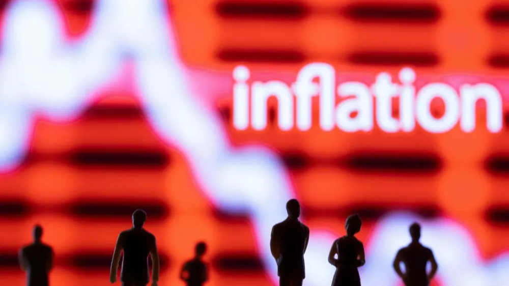 FILE PHOTO: Figurines are seen in front of displayed stock graph and word "Inflation" in this illustration taken June 13, 2022. REUTERS/Dado Ruvic/Illustration/File Photo