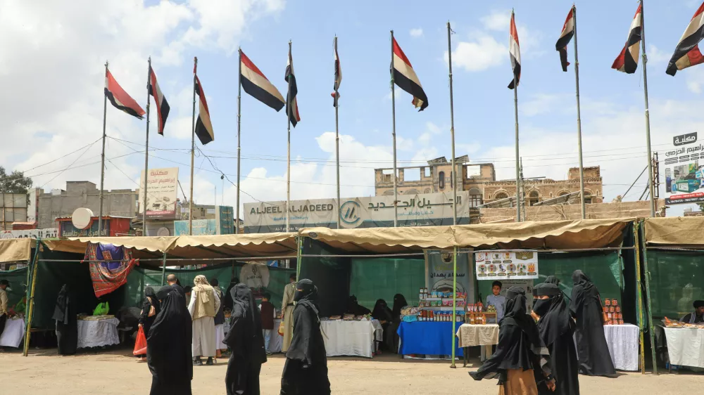 People walk past Yemeni flags in Sanaa, Yemen, Thursday, Sept. 17, 2026. (AP Photo/Osamah Abdulrahman)