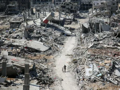 A man pushes a bycicle along as he walks amid building rubble in the devastated area around Gaza's Al-Shifa hospital on April 3, 2024, amid the ongoing conflict between Israel and the Palestinian Hamas militant group.,Image: 862136714, License: Rights-managed, Restrictions:, Model Release: no 