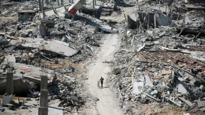 A man pushes a bycicle along as he walks amid building rubble in the devastated area around Gaza's Al-Shifa hospital on April 3, 2024, amid the ongoing conflict between Israel and the Palestinian Hamas militant group.,Image: 862136714, License: Rights-managed, Restrictions:, Model Release: no 