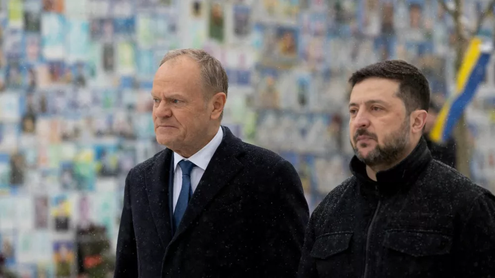 FILE PHOTO: Ukraine's President Volodymyr Zelenskiy and Polish Prime Minister Donald Tusk visit the Wall of Remembrance of the Fallen for Ukraine outside the Saint Michael's Cathedral, amid Russia's attack on Ukraine, in Kyiv, Ukraine February 5, 2026. Ukrainian Presidential Press Service/Handout via REUTERS ATTENTION EDITORS - THIS IMAGE HAS BEEN SUPPLIED BY A THIRD PARTY/File Photo/File Photo
