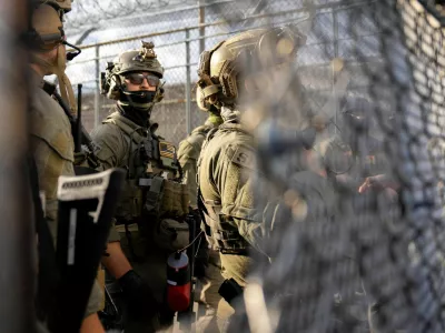 U.S. Immigration and Customs Enforcement (ICE) agents and federal agents secure the entrance to the Delaney Hall detention center, as demonstrators remain gathered outside, in Newark, New Jersey, U.S., May 29, 2026. REUTERS/David 'Dee' Delgado