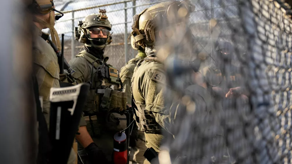 U.S. Immigration and Customs Enforcement (ICE) agents and federal agents secure the entrance to the Delaney Hall detention center, as demonstrators remain gathered outside, in Newark, New Jersey, U.S., May 29, 2026. REUTERS/David 'Dee' Delgado