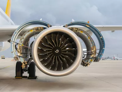 Jet engine. A modern, new generation, jet-powered passenger aircraft is waiting at the airport. Aircraft parked with open hatches for jet engine maintenance.