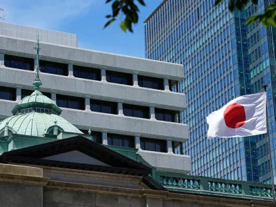 FILE - A Japanese flag flutters at the Bank of Japan headquarters in Tokyo, July 29, 2022. (AP Photo/Shuji Kajiyama, File)