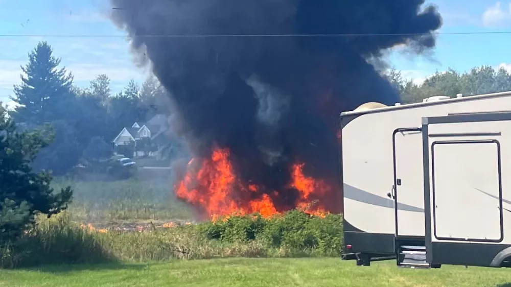 Smoke rises after an F-16 fighter jet crashed in a rural area near Traverse City, Mich., Thursday, Sept. 17, 2026. (Rebecca Lamberson via AP)