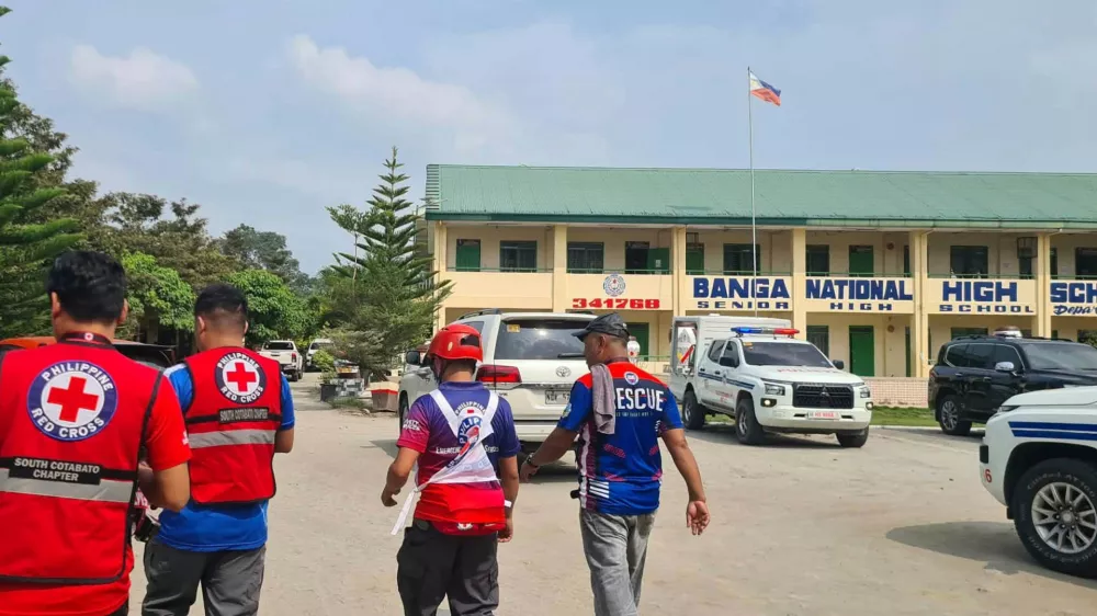 In this handout photo provided by the Philippine Red Cross, Red Cross members arrive at Banga National High School in the town of Banga, Philippines, Friday, Sept. 18, 2026. (Philippine Red Cross via AP)