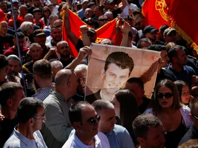 A man holds an image of former Kosovo President Hashim Thaci, during a protest called by war veterans following a Hague court verdict sentencing former Kosovo Liberation Army (KLA) leaders, including Thaci, for war crimes, in Pristina, Kosovo, September 18, 2026. REUTERS/Valdrin Xhemaj