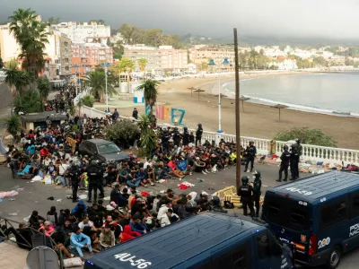 Police escort migrants from Benitez Beach to be relocated to the camp set up at the port of Ceuta, Spain, September 18, 2026. REUTERS/ Anna Surinyach