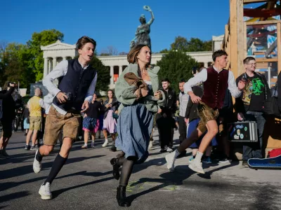 People run to enter the 191st Oktoberfest beer festival in Munich, Germany, Saturday, Sept.19, 2026. (AP Photo/Matthias Schrader)