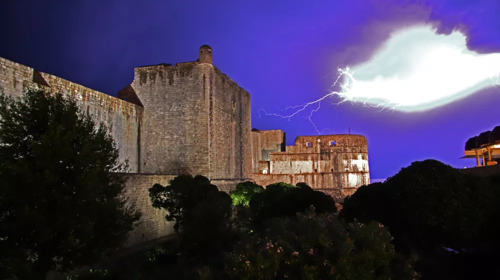 The storm, the lightning. Pile gate of the fortress at night in Dubrovnik on Adriatic sea, Croatia