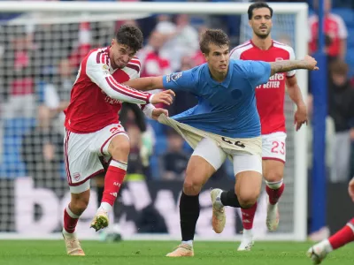 Arsenal's Kai Havertz pulls Brighton's Luka Vuskovic during the English Premier League soccer match between Brighton & Hove Albion and Arsenal in Brighton, England, Saturday, Sept. 19, 2026. (AP Photo/Kin Cheung)