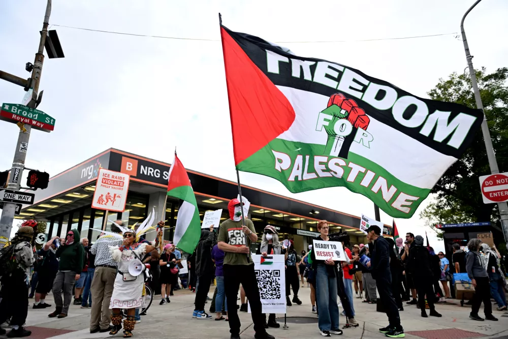 Pro-Palestinian demonstrators waves a flags and hold signs during a protest before an Ed Sheeran concert in Philadelphia, Saturday, Sept. 18, 2026. (AP Photo/Allie Ippolito)