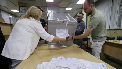 Members of a local electoral commission empty a ballot box before counting votes after the closure of polling stations on the final day of Russia's three-day parliamentary election in Vladivostok, Russia, September 20, 2026. REUTERS/Tatiana Meel