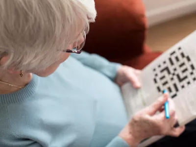 Senior Woman Doing Crossword Puzzle At Home