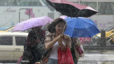 People hold their umbrellas while walking against strong winds caused by Typhoon Dujuan in Taipei, Taiwan, September 28, 2015. REUTERS/Pichi Chuang