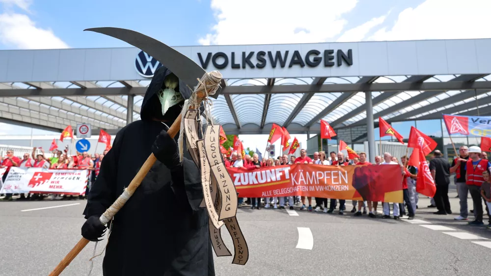 Workers stage a protest in front of the Volkswagen plant in Zwickau, Germany, Thursday, July 9, 2026. (Jan Woitas/dpa via AP)