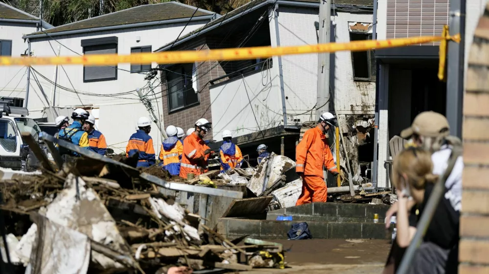 Rescue workers conduct a rescue and search operation for a missing person at a house hit by a landslide triggered by Typhoon Dujuan in Miura, Kanagawa Prefecture, Japan, September 22, 2026, in this photo taken by Kyodo. Mandatory credit Kyodo/via REUTERS ATTENTION EDITORS - THIS IMAGE HAS BEEN SUPPLIED BY A THIRD PARTY. MANDATORY CREDIT. JAPAN OUT. NO COMMERCIAL OR EDITORIAL SALES IN JAPAN.