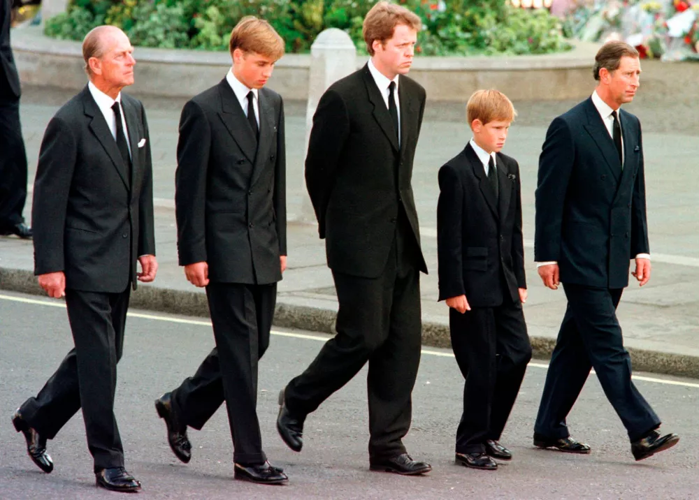 FILE - From left: Britain's Prince Philip, Prince William, Earl Spencer, Prince Harry and Prince Charles walk outside Westminster Abbey during the funeral procession for Diana, Princess of Wales, Sept. 6, 1997. (AP Photo/Jeff J. Mitchell, Pool, File)