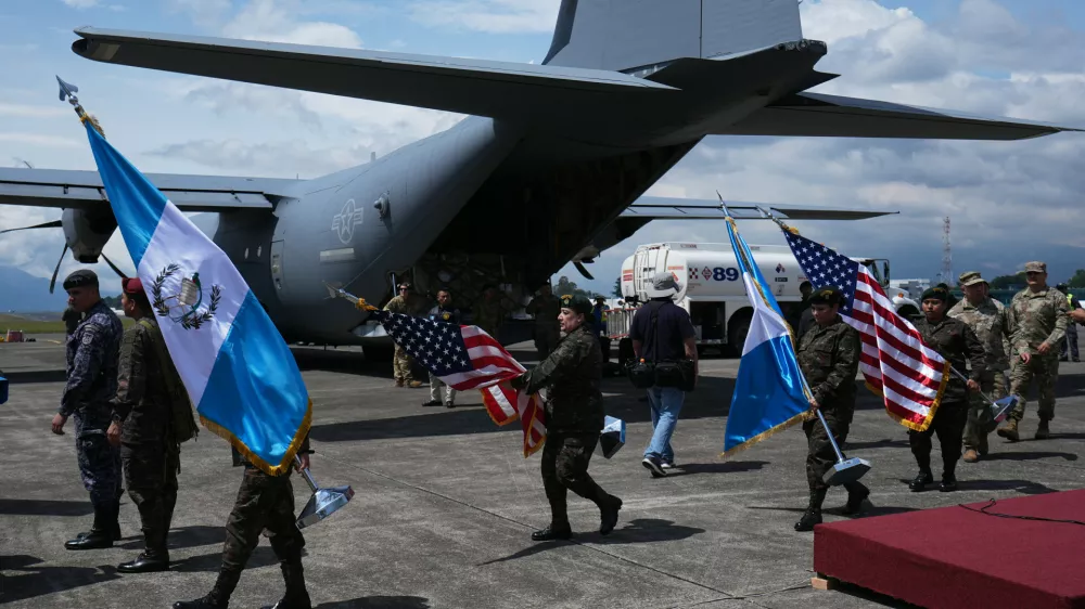 Soldiers carry Guatemalan and U.S. flags as they prepare for a ceremony to receive purchased U.S. military equipment after more than 40 years of a U.S.-imposed arms embargo on Guatemala over human rights violations in Guatemala City, Monday, Sept. 21, 2026. (AP Photo/Moises Castillo)