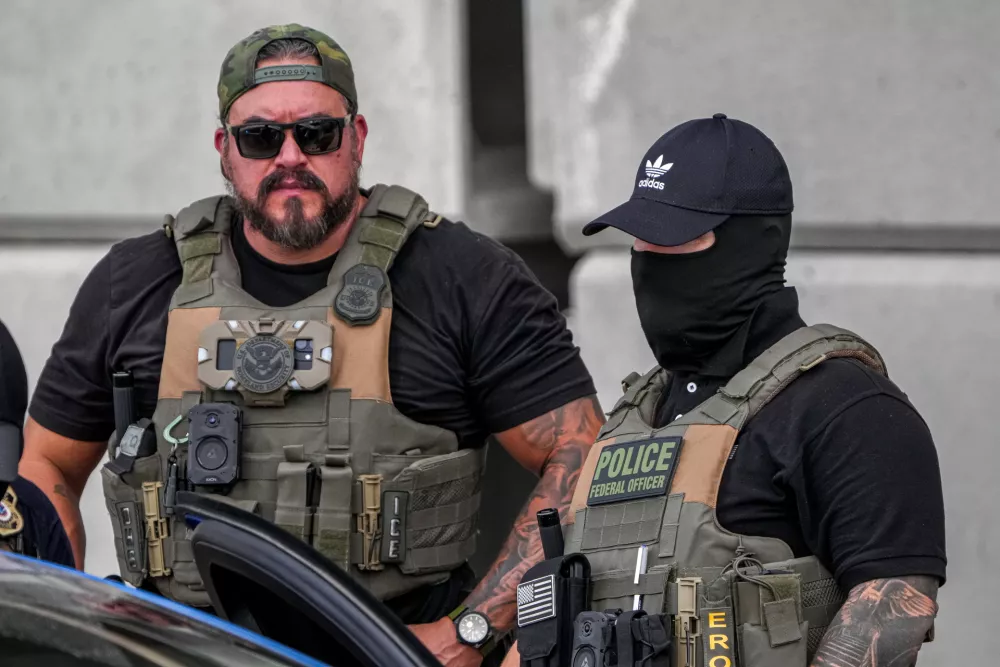 Immigration and Customs Enforcement officers stand at the scene where a man was shot in his vehicle by an ICE officer, Sunday, Sept. 20, 2026, in Austin, Texas. (Aaron E. Martinez /Austin American-Statesman via AP)