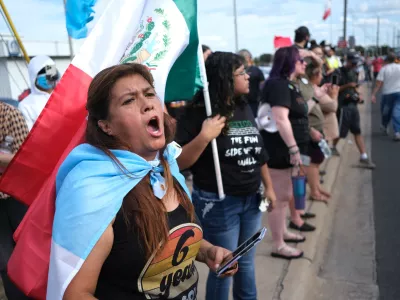People protest where local authorities say a U.S. Immigration and Customs Enforcement officer (ICE) shot and wounded a man in Austin, Texas, Sunday, Sept. 20, 2026. (AP Photo/Joel Angel Juarez)