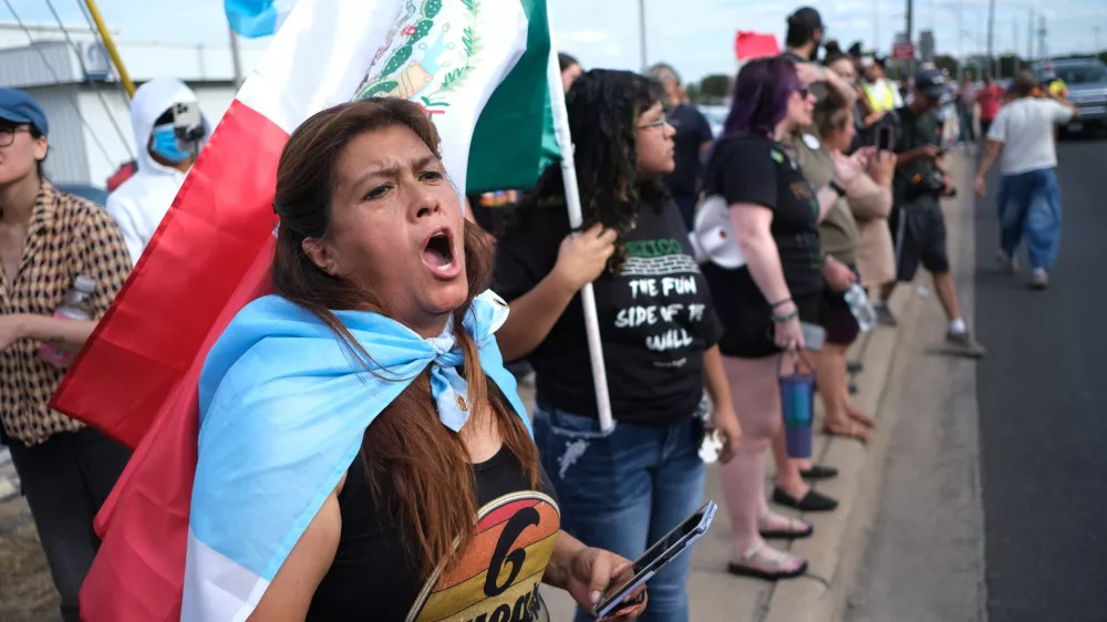 People protest where local authorities say a U.S. Immigration and Customs Enforcement officer (ICE) shot and wounded a man in Austin, Texas, Sunday, Sept. 20, 2026. (AP Photo/Joel Angel Juarez)