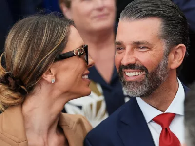 FILE - Donald Trump Jr., speaks with his wife Bettina, left, as they wait for President Donald Trump to deliver remarks to U.S. embassy staff at Deerfield Residence in Dublin, Sept. 12, 2026. (AP Photo/Julia Demaree Nikhinson, File)