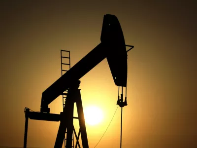 FILE- In this Wednesday, June 8, 2011 file photo, sun sets behind an oil pump in the desert oil fields of Sakhir, Bahrain. (AP Photo/Hasan Jamali, File)