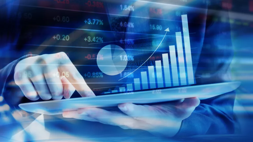 Business woman are checking stock market graph on digital tablet