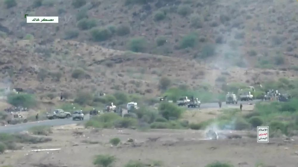 Smoke rises from a vehicle as armed men take to the streets at a location given as Khalid Camp, near Mocha, and said to show Houthi fighters firing towards government forces backed by Saudi Arabia, in Yemen, in this screengrab taken from a video released September 22, 2026. Al Masirah/Handout via REUTERS  THIS IMAGE HAS BEEN SUPPLIED BY A THIRD PARTY. TEXT OVERLAY FROM SOURCE.  REFILE - ADDED LOCATION AND CONTEXT. Verification: Reuters was able to verify the location from timecodes 0:21 to 0:28; 0:47 to 0:55; 01:42 to 01:50; 2:13 to 2:19 with the buildings, infrastructure and port layout that matched the archive and satellite imagery of the area. Location not verified from timecodes 0:00-0:20; 0:29- 0:46; 0:56-01:41; 01:51-2:12; 2:20- 3:03. The date when the videos were filmed was not verified. No old results were found posted online before September 22.